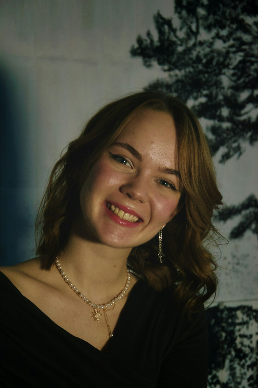 Studio portrait of a woman with short brown hair smiling