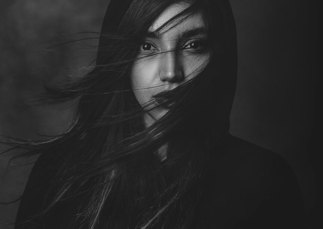 Studio portrait of a woman with long dark hair