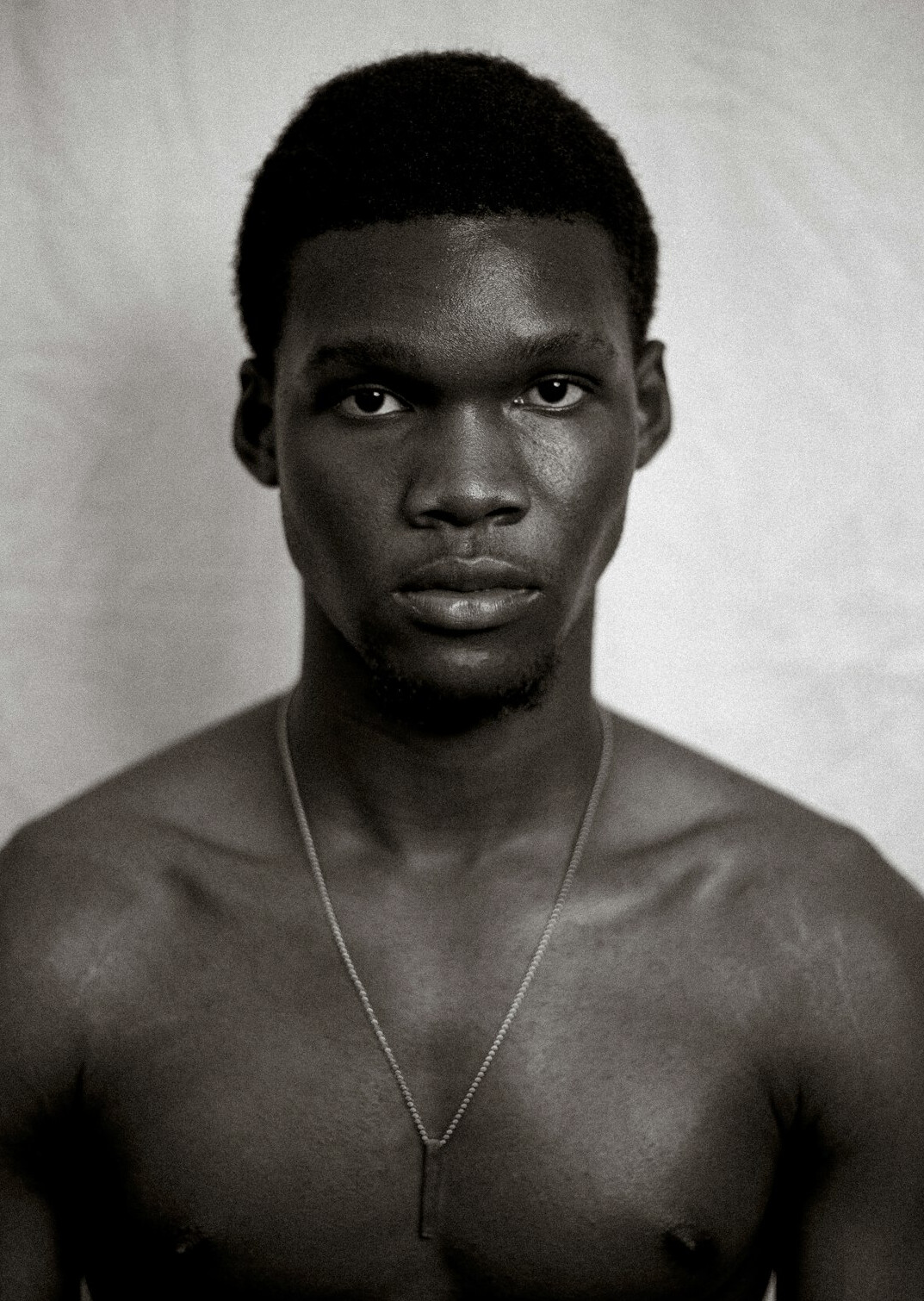 Studio portrait of a man with dark skin and short hair